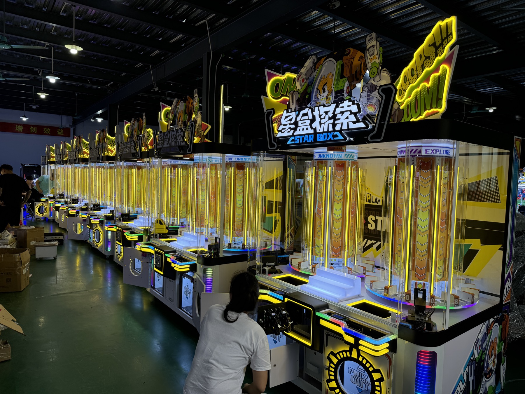 Jiuyou production team member checking finished arcade machines