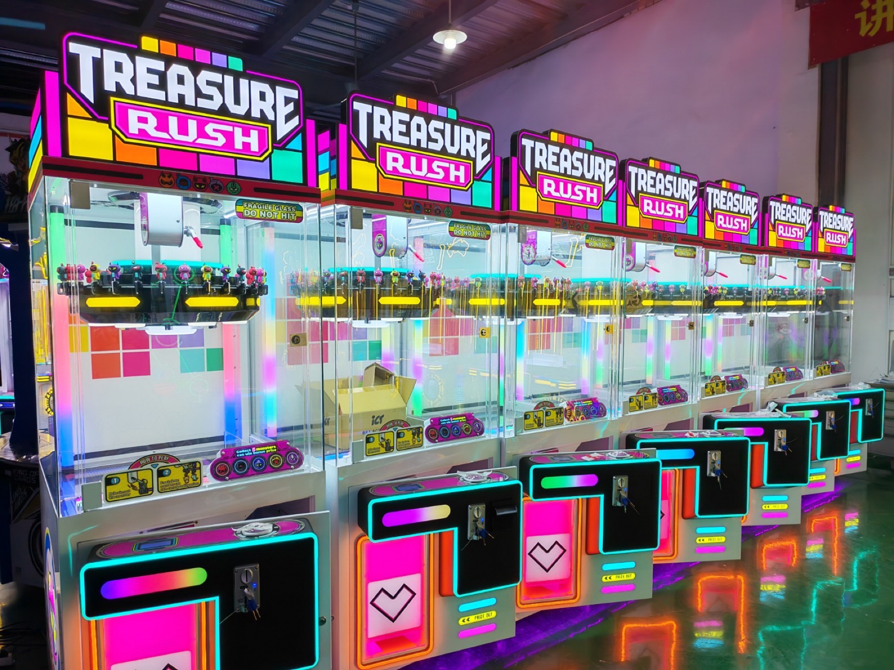 Rows of finished Jiuyou arcade machines illuminated for inspection