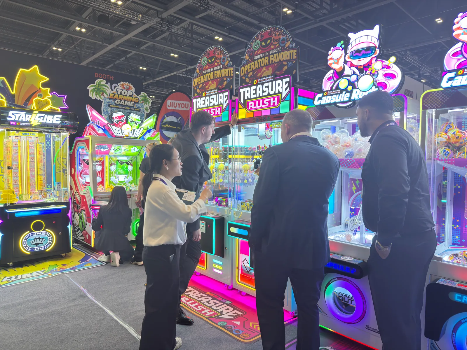Visitors and a Jiuyou team member beside Capsule Rock and Treasure Rush
