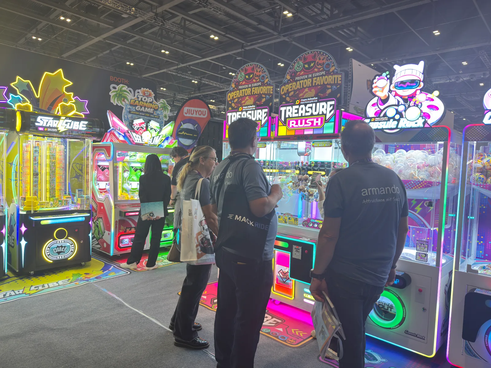Visitors looking at the Treasure Rush machines at the Jiuyou stand